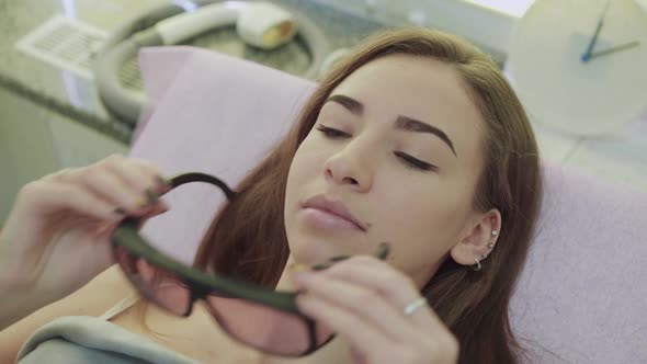 Portrait of Pretty Girl Wearing Protective Glasses in Cosmetology Studio