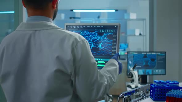 Scientist Working in Laboratory Analysing Test Trial Vaccine