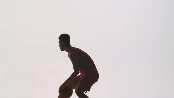 Silhouettes of Two Guys Athletes Basketball Players Practicing the Skills of Attack and Defense