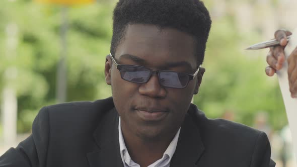 Afro-american Businessman Ordering in Outside Cafe