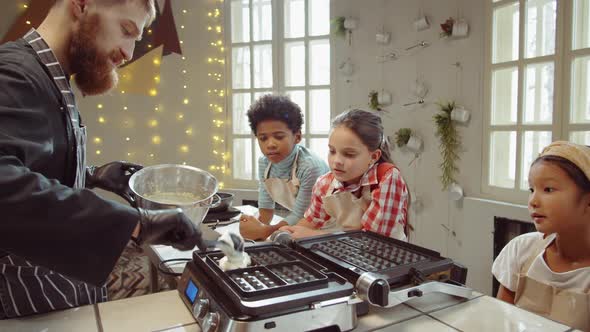 Chef Teaching Kids How to Cook Waffles on Culinary Class