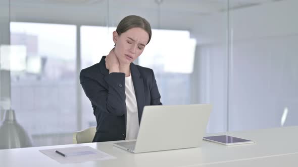 Hardworking Young Businesswoman Having Neck Pain in Office