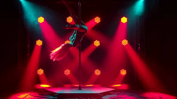 Silhouettes of a Slender Exotic Dancer Rotating Beautifully on a Pole