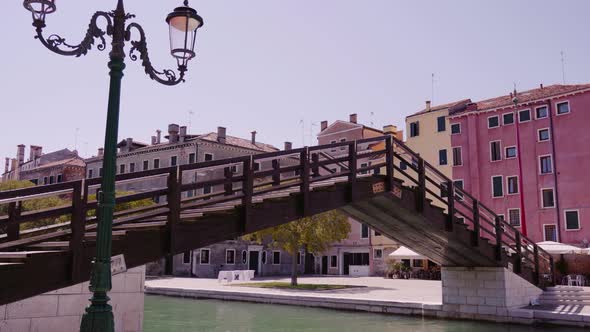 Motion Under Bridge with Wooden Steps Along Street Channel