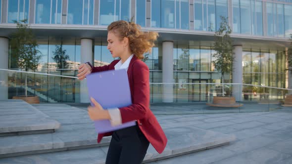 Young Business Woman Looking at Watch and Running Near Office Building Hurry To Meeting