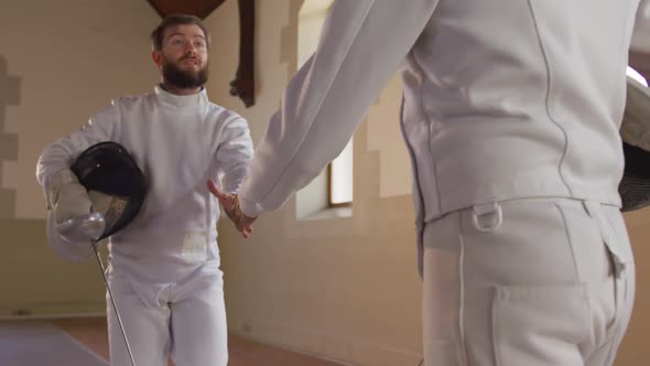 Fencer athletes during a fencing training in a gym