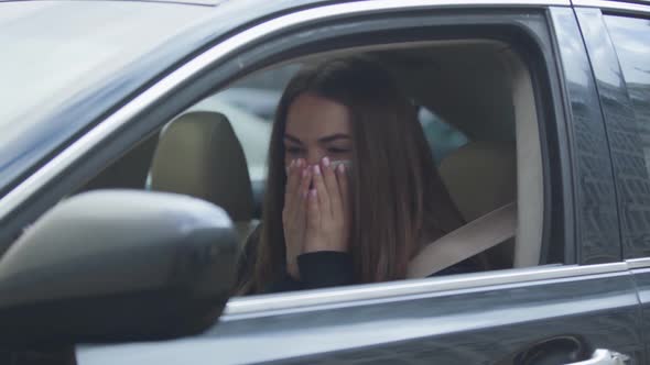 Portrait of Exhausted Woman with Severe Coughing Sitting in Car and Closing Side Window