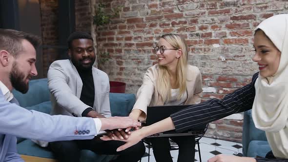 Multiracial Business People Putting their Hands on Hands to Motivate Successful Work Together