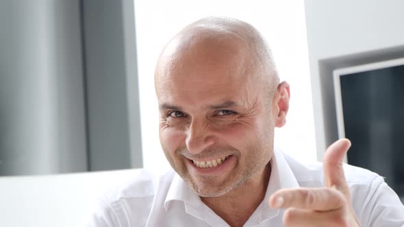 Portrait of a Smiling Bank Employee He Looks Into the Camera Lens and Winks