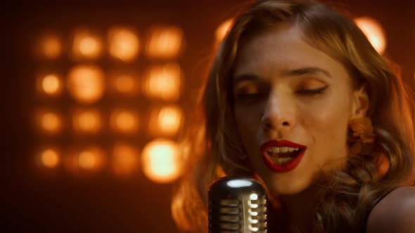 Blonde Girl Singing Microphone in Nightclub Close Up