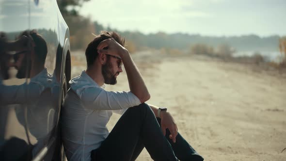 Sad Dissapointed Man.Sad Man Sitting On Broken Car.Exhausted Sad Man.Broken Car.Stressed Driver.