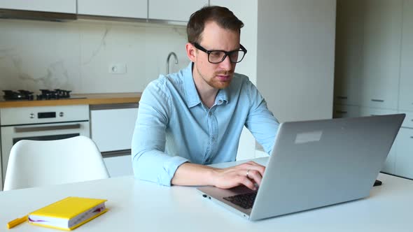 Smart Young Businessman Using Laptop Computer for Remote Work From Home