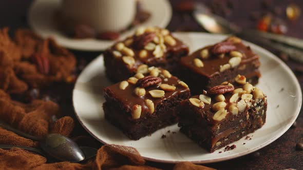 Chocolate Cake with Caramel Frosting, Pecans and Hot Coffee, on Rustic Background. Freshly Baked