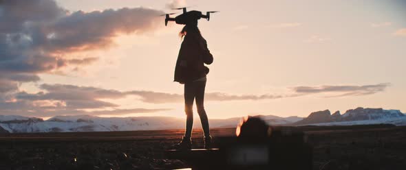 Person flies a drone during sunset