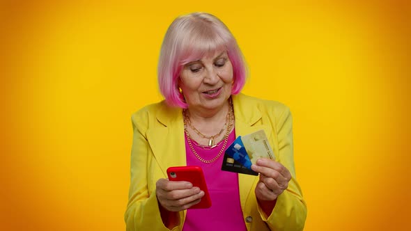 Senior Old Granny Woman Using Credit Plastic Cards and Mobile Phone Purchases Online Shopping