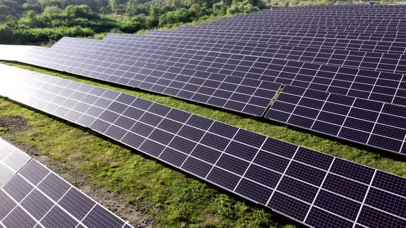 Close up solar power station panels in a row in the fields green energy at sunset