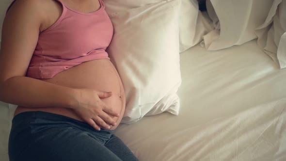 Happy Pregnant Woman and Expecting Baby at Home