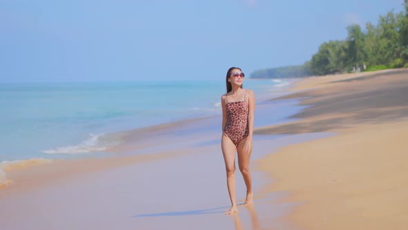 Asian woman enjoy around beautiful beach sea ocean