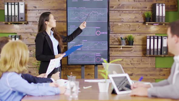 Young Business Woman in Suit Having a Successful Presentation