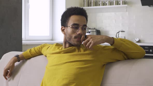 Thoughtful African Guy Sitting on the Couch