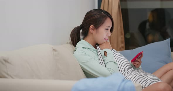 Woman watch on cellphone at home