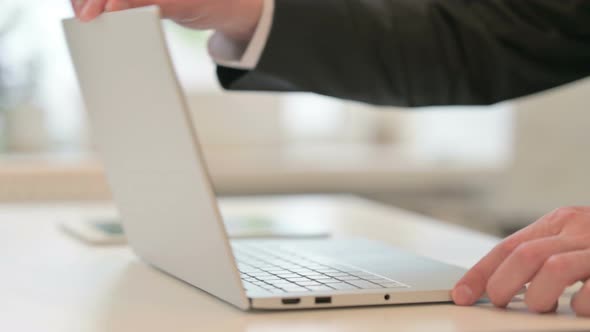 Close Up of Hands of Middle Aged Businessman Typing on Laptop