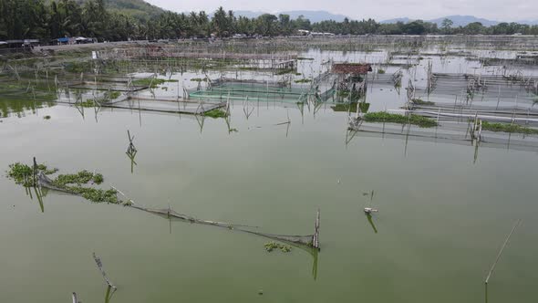 Aerial view of traditional floating fish pond on swamp in Indonesia