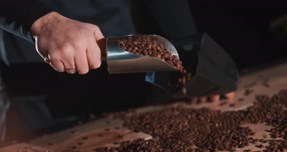 Roasted Coffee Beans Fly and Spin on a Black Background in Slow Motion
