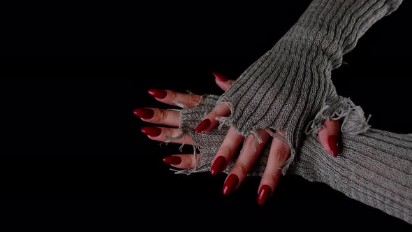 Women's Hands with Red Nails on Black Background