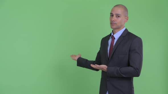 Stressed Bald Multi Ethnic Businessman Showing To Back