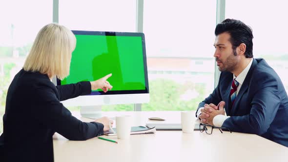 Two Business People Talk Project Strategy at Office