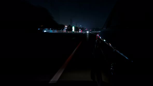 Drivelapse Urban Look From Fast Driving Car at a Night Avenue in a City Timelapse Hyperlapse