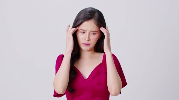 Asian woman in red dress have a headache and Migraine feeling so stressed isolated on white