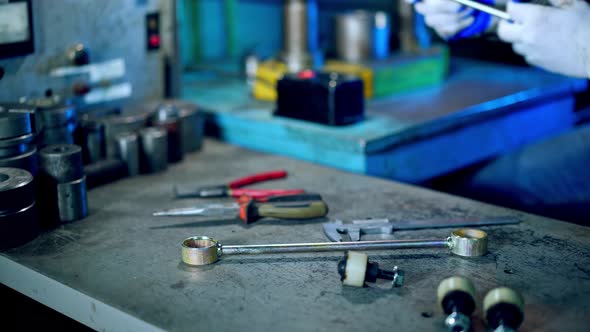 Metal Formation by Hydraulic Press. Worker at manufacture workshop operating metal press machine