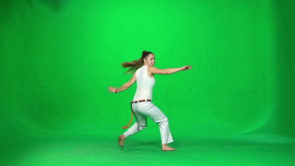 Woman with Long Hair Practicing Capoeira on Chroma Key Studio. Slow Motion.