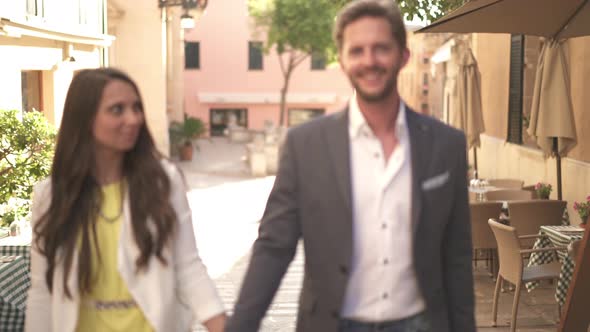 Well Dressed Young Couple Walking in Pedestrian Zone