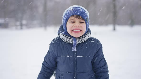 Portrait of a Boy in Winter Showing Teeth