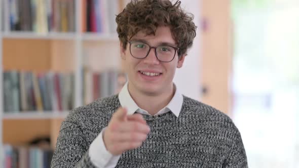 Portrait of Young Man Pointing with Finger