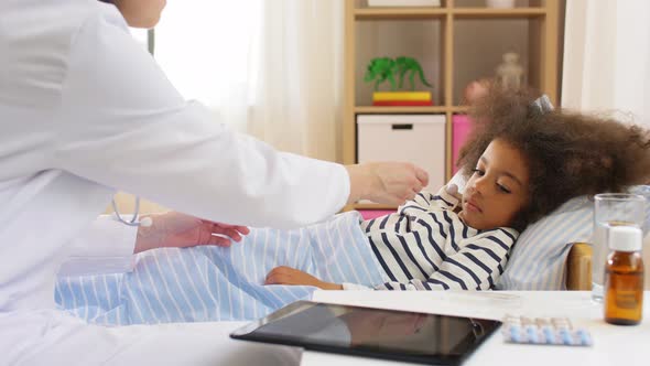 Doctor Measuring Sick Girl's Temperature