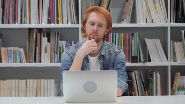 Pensive Man Thinking and Working on Laptop