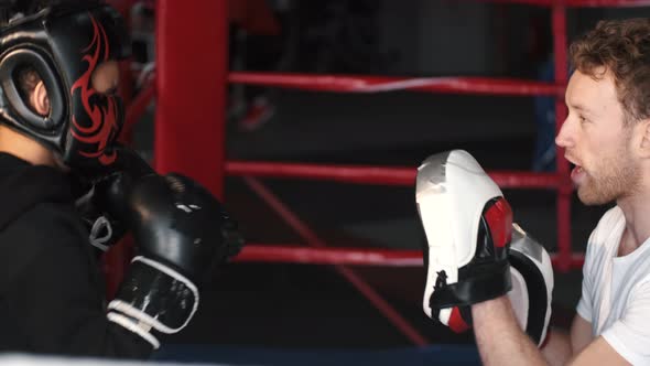 Boy Boxer Practicing Punches with His Coach at Gym