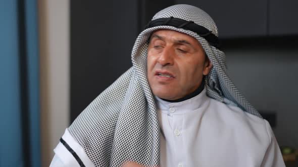 Closeup Portrait of Angry Middle Eastern Man Looking at Camera with Dissatisfied Facial Expression