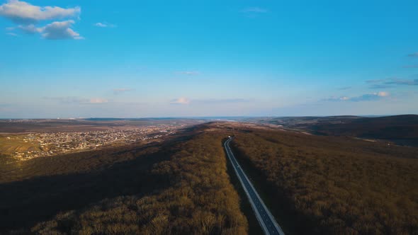 Aerial View of Cars Traveling Middle of the Forest on the Road