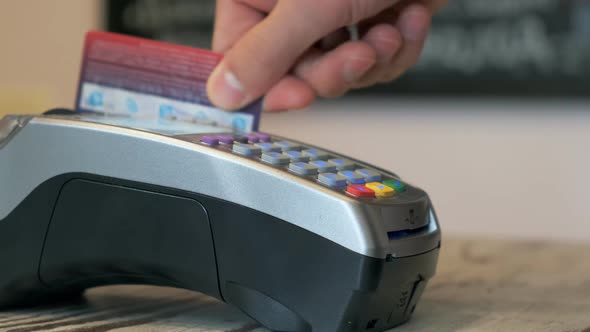 Person Using a Credit Card To Pay for the Bill at a Restaurant