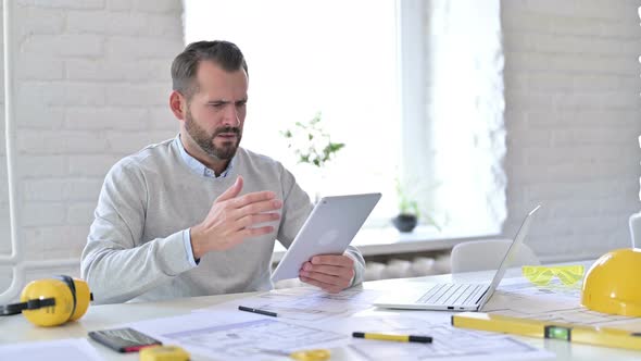 Failure, Young Architect Having Loss on Tablet in Office 