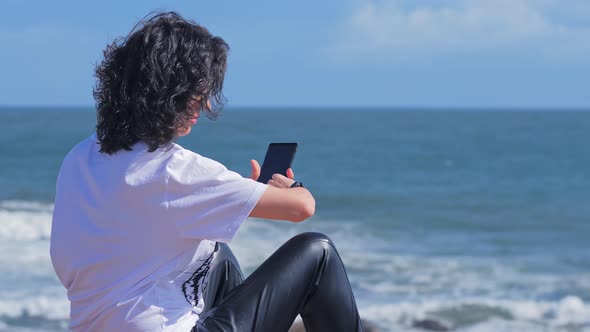 Young Woman Typing Chat Message on Cell Phone