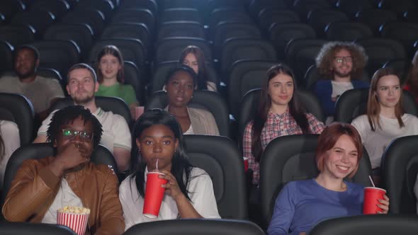 Multiracial Audience Watching Comedy in Cinema.