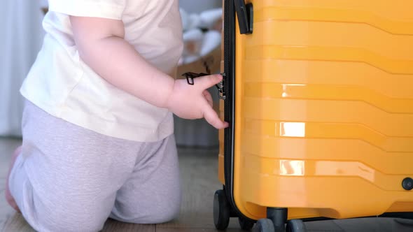 Baby Girl with Yellow Suitcase Baggage and Clothes Ready for Traveling on Vacation Child Playing