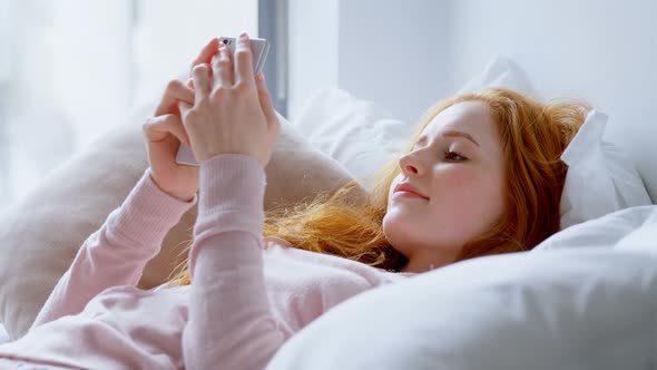 Woman using mobile phone in bedroom 4k