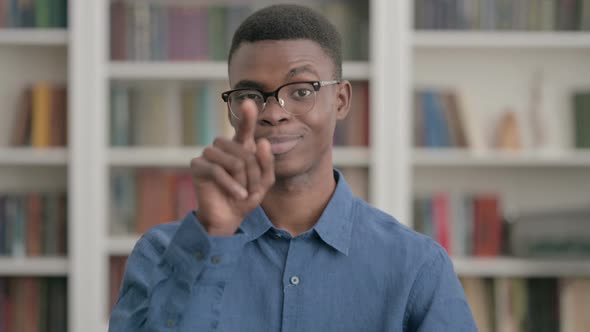 Young African Man Pointing at the Camera and Inviting